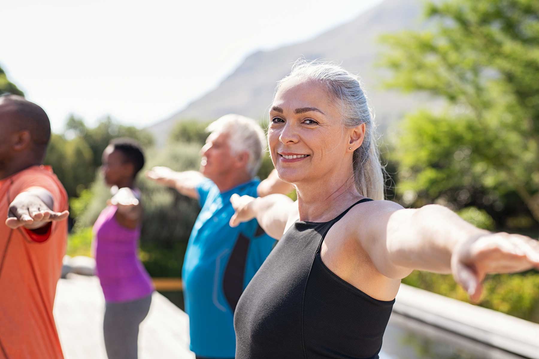 Woman with hearing loss enjoying an exercise class.